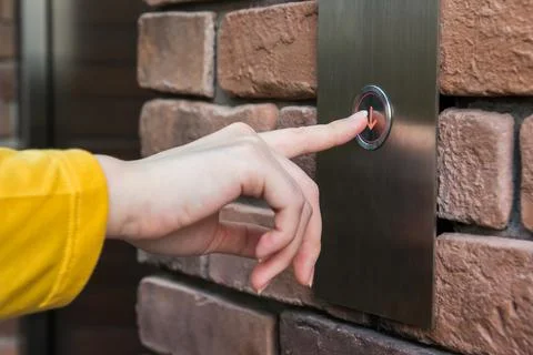 Young woman pressing elevator button Stock Photos