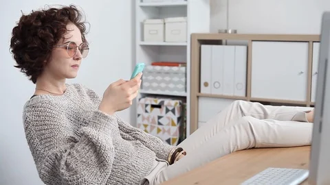 Young Woman Procrastinates Scrolling her Smartphone Stock Footage 107249537