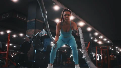 Young woman professional trainer performs exercises with ropes Stock Footage 170244226