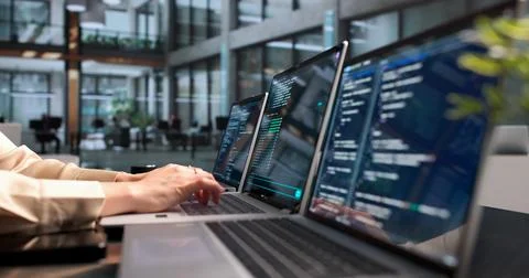 Young Woman Programmer Coding Cloud Projects On Laptop In Office Workspace. Fotos Stock