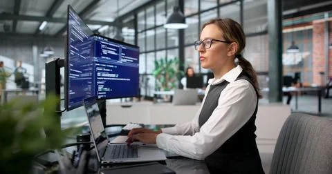 Young Woman Programmer Is Coding Secure Software At Her Modern Office Desk. Stockfoto's