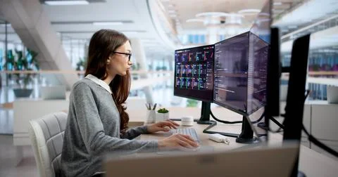 Young Woman Programmer Focused On Coding Software Solutions At Desk. Stock Photos