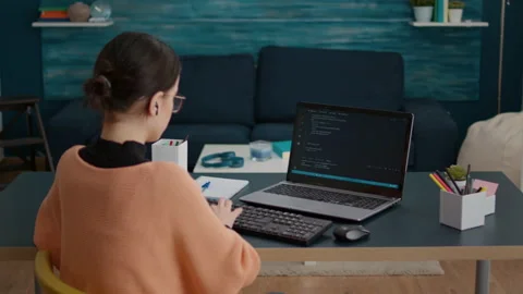 Young woman programming binary code on laptop screen Stock Footage 171944967