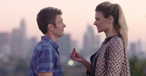 Young woman proposes to her boyfriend in Los Angeles at sunset 4K Stock Footage