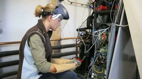 Young woman with protective mask controlling electrical intensity Stock Footage 51574553