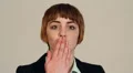 Young woman puckers up and blows a kiss at the camera HD Footage