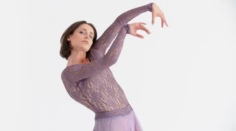Young Woman in a Purple Dress Doing Modern Dance on a White Background Stock Footage