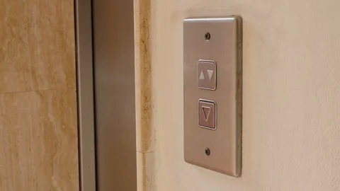 Young woman pushes elevator button to go down. Elevator button push. Slow motion Stock Footage 106472671