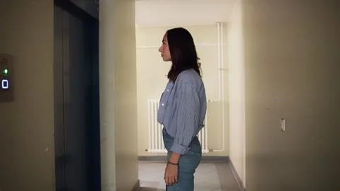 Young Woman Pushing Elevator Call Button, Waiting Stock Footage 314523418