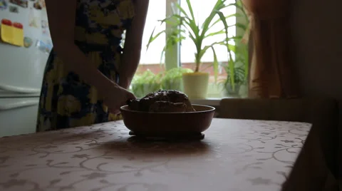 Young woman puts the pan on the table Stock Footage 45665666