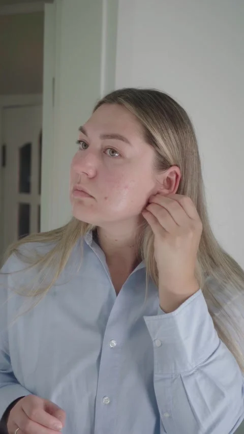 Young Woman Putting On Earring While Dressing For Online Job Interview Stock Footage 342053349