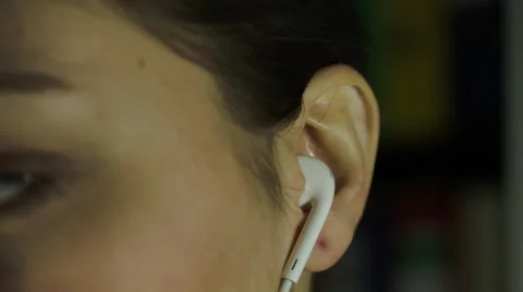 Young Woman Putting Headphones Earbud In Ear Stock Footage 59559924