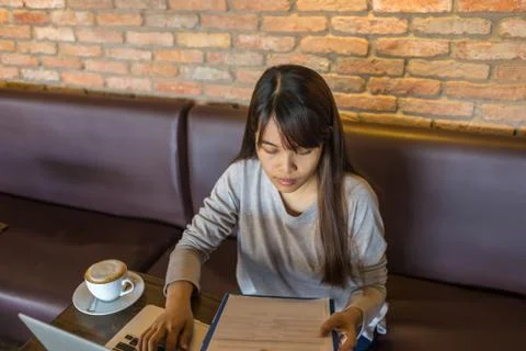 Young woman reading data on document Foto stock