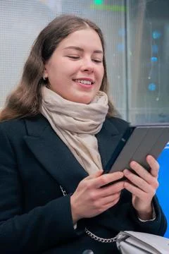 Young Woman Reading on E-Reader While Commuting on Subway Train.Vertical Stock Photos