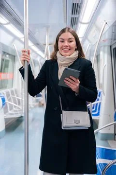 Young Woman Reading on E-Reader While Commuting on Subway.vertical Stock Photos