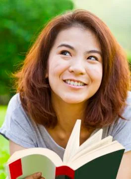 Young woman reading in the park Stock Photos