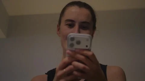 Young woman reading a text message on her smartphone... Video stock 337971355