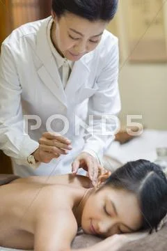 Young Woman Receiving Acupuncture