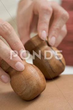 Young woman receiving massage with wooden stamps, close-up Stock Photos