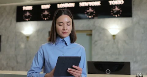 Young woman receptionist using tablet Stock Video Pond5