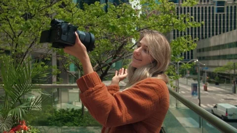 Young woman record vlog using mirrorless video camera on the city background Stock Footage 247297390