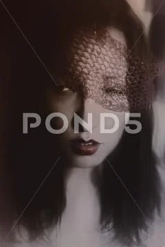 Young woman in red veil closeup Stock Photos