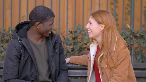 Young woman refusing black man's kiss in the park. Friend zone Stock Footage 106352163