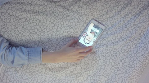 Young woman rejects call while lying on bed in hotel room Stock Footage 238470182