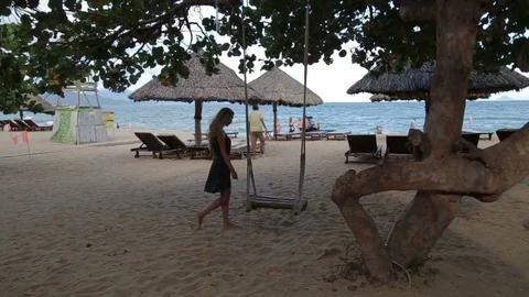 Young woman relax on the swing at the beach Stock-Footage 70765853