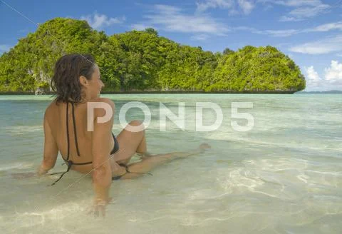 Young woman relaxes on a tropical beach Stock Photos