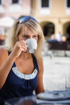 Young woman relaxing and drinking coffee Stock Photos