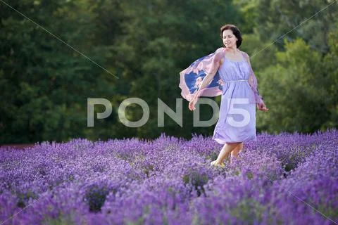 Young woman relaxing in lavender field Stock Photos