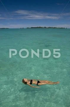 Young Woman relaxing in tropical water Stock Photos