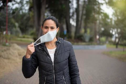 Young woman removing mask during coronavirus disease pandemic in Latin America, Stock Photos