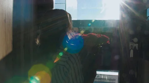 Young woman rises in the Elevator with a view of the sea, flowers Video stock 126225286