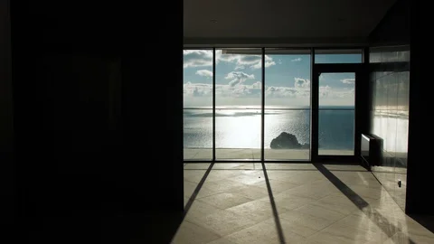 Young woman rises in the Elevator with a view of the sea, flowers Video stock 126225515