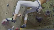 Young Woman Rock Climber Is Climbing At Inside Climbing Gym. Slim Pretty Woman Stock Footage