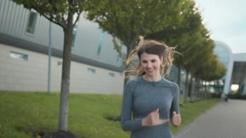 Young woman runner training in summer park city. Portrait of young and fit woman Stock Footage 155102469