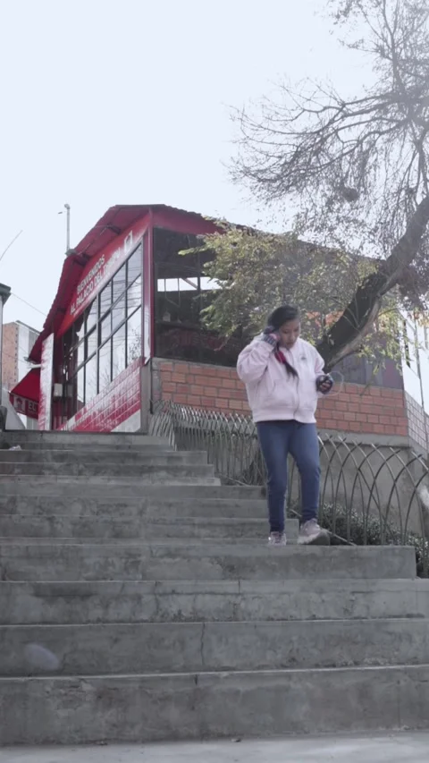 A young woman running down the steps hurriedly Stock Footage 314912820