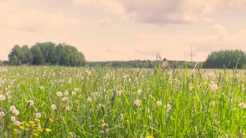 Young woman running on the meadow Stock Footage