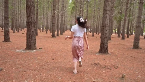 Young woman running through empty woods Stock Footage 220759923