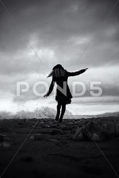 Young woman on the sandy beaches of the storm Stock Photos