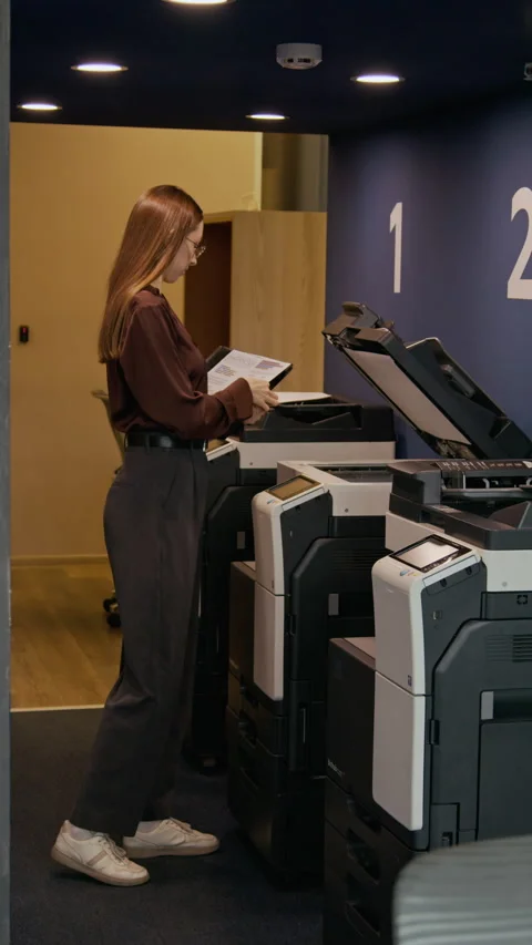 Young Woman Scanning Document with Multifunctional Printer in Office Stock Footage 333395466