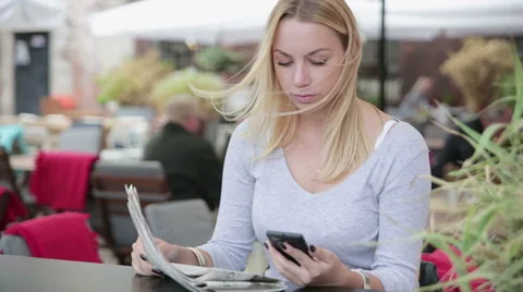 Young woman scanning qr code with smart phone from newspaper HD Stock Footage 41515952