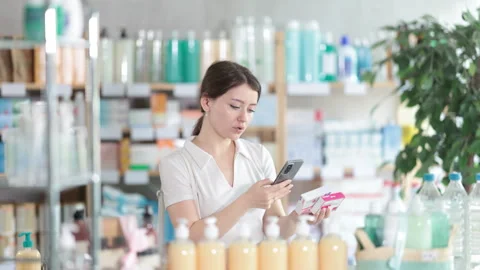 Young woman scanning qr code of paracetamol Stock Footage 311352942