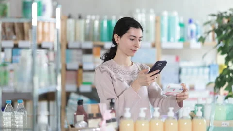 Young woman scanning qr code of paracetamol Stock Footage 317141400