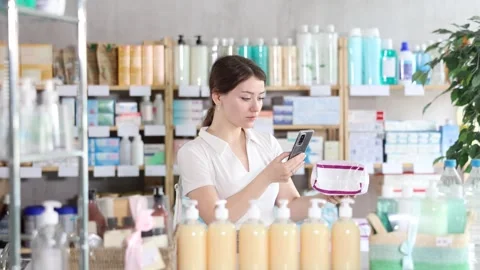 Young woman scanning qr code of feminine pads Stock Footage 317985559