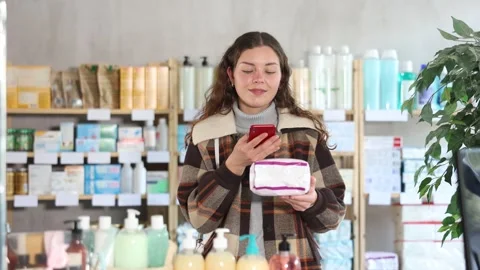 Young woman scanning qr code of feminine pads Stock Footage 318943016