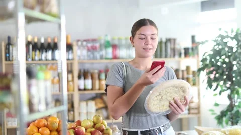 Young woman scanning qr code for four cheese pizza Stock Footage 320923096