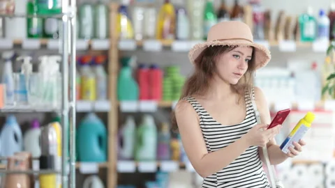 Young woman scanning qr code for repellent Stock Footage 321723878
